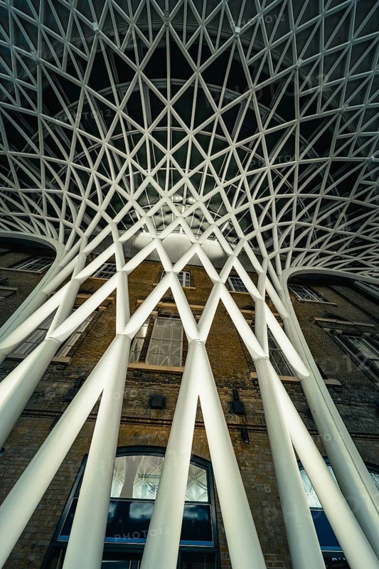 Futuristic geometric ceiling pattern with white pillars in modern architecture, King's Cross Station, London, United Kingdom, World