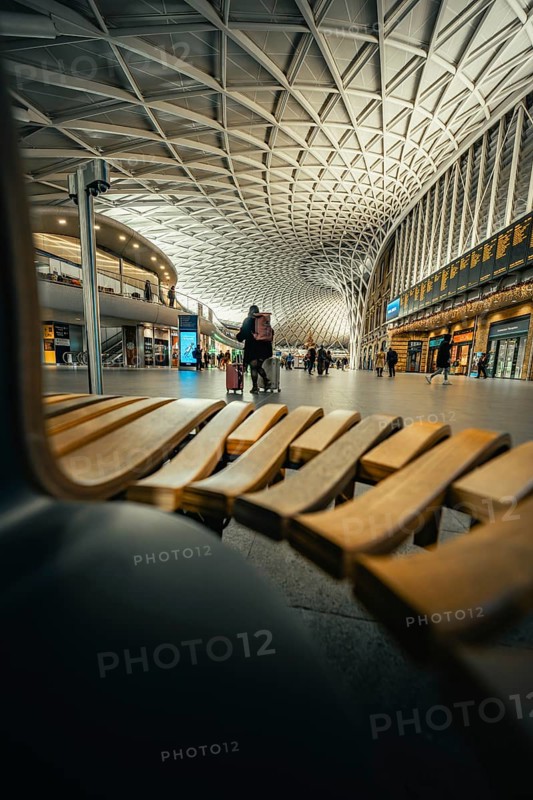 Modern station concourse with eye-catching ceiling patterns and people in a lively atmosphere, King's Cross Station, London, United Kingdom, World