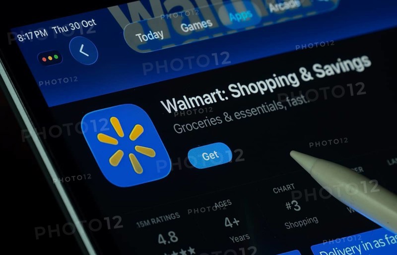 Dhaka, Bangladesh- 30 Oct 2025: Walmart app displayed on a iPad screen in dark mode with a digital pen pointing at it