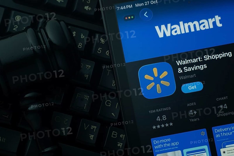 Dhaka, Bangladesh- 28 Oct 2025: An iPad displaying the Walmart app against a judge's gavel and dark keyboard background