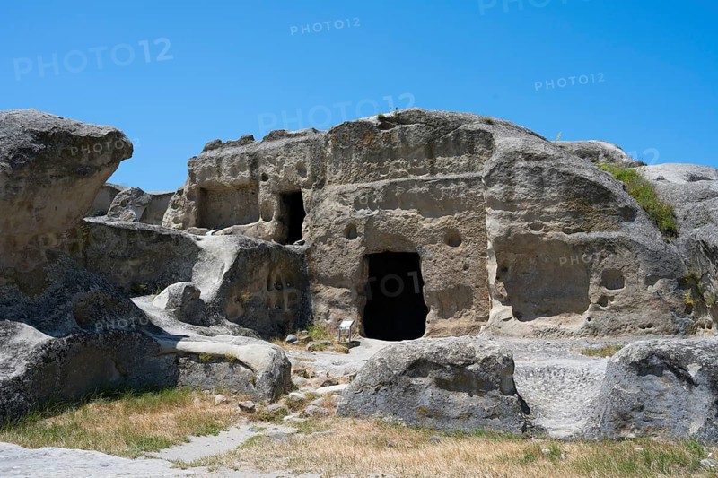 Ancient rock structure with several cave entrances in natural surroundings, Uplistsikhe cave town, Uplistsikhe, Inner Kartli region, Shida Kartli, Georgia
