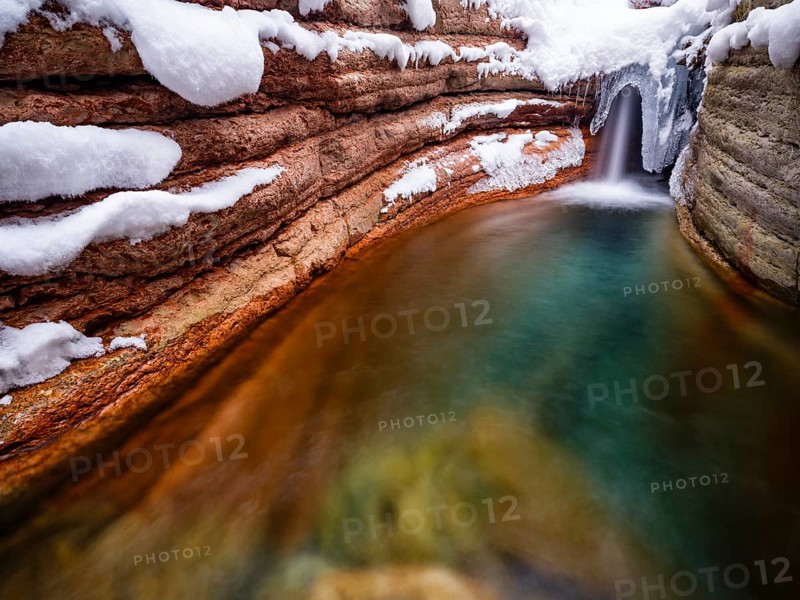 Taugl or Tauglbach flows through the snow-covered and icy red gorge, also Marmorklamm, Bad Vigaun, Tennengau, Salzburg, Austria