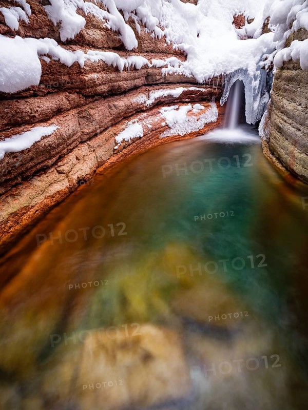 Taugl or Tauglbach flows through the snow-covered and icy red gorge, also Marmorklamm, Bad Vigaun, Tennengau, Salzburg, Austria