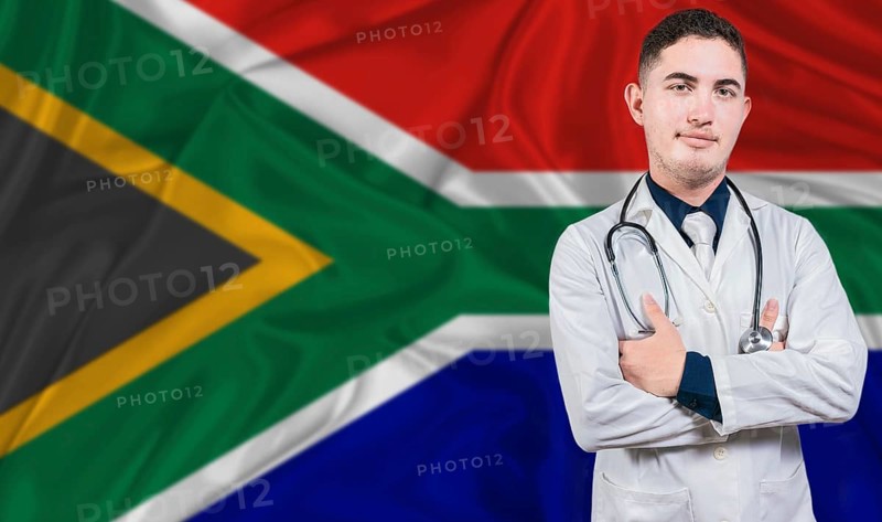 Portrait of medical professional on South Africa flag background. South African national health system
