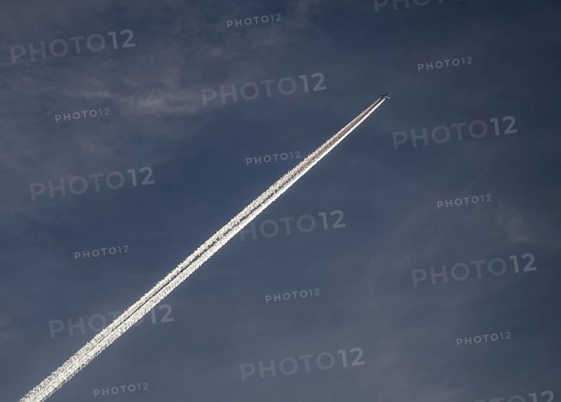 Contrails and passenger jets high in the sky