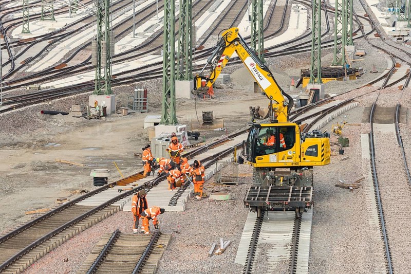 Construction workers work with a crane truck on a section of rail in a large track area, Untertürkheim parking station, Stuttgart, Baden-Württemberg, Germany