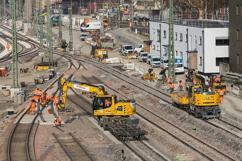 Several workers and excavators on a railway construction site in an urban area, Untertürkheim parking lot, Stuttgart, Baden-Württemberg, Germany