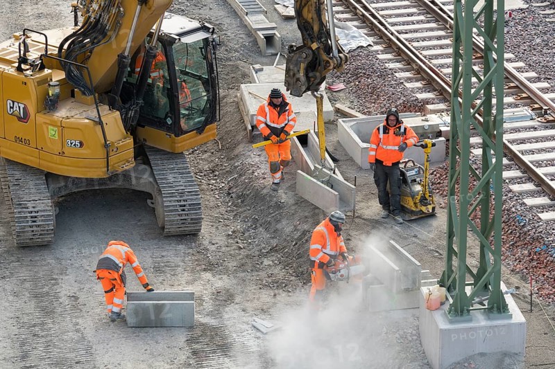 Construction workers use construction machinery to lay rail structures, cutters, vibrators, Untertürkheim parking station, Stuttgart, Baden-Württemberg, Germany