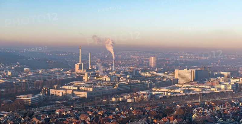 Extensive city view at sunrise with industrial plants and smoke developments, view of Daimler Group headquarters, Untertürkheim plant, Stuttgart, Baden-Württemberg, Germany