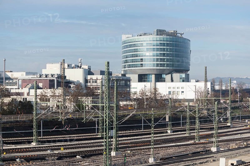 Modern building in an industrial area with railroad tracks in the foreground under clear skies, view of Daimler headquarters, Untertürkheim plant, Stuttgart, Baden-Württemberg, Germany