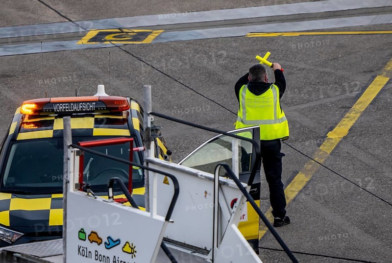 Instructor, apron supervision, an aircraft, after landing, at the parking position, at the terminal, gates, at the passenger bridge, Cologne/Bonn airport, CGN, North Rhine-Westphalia, Germany