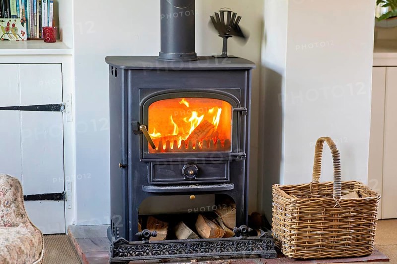 Logs burning in roaring fire of Clearview stove in domestic residential living room, UK