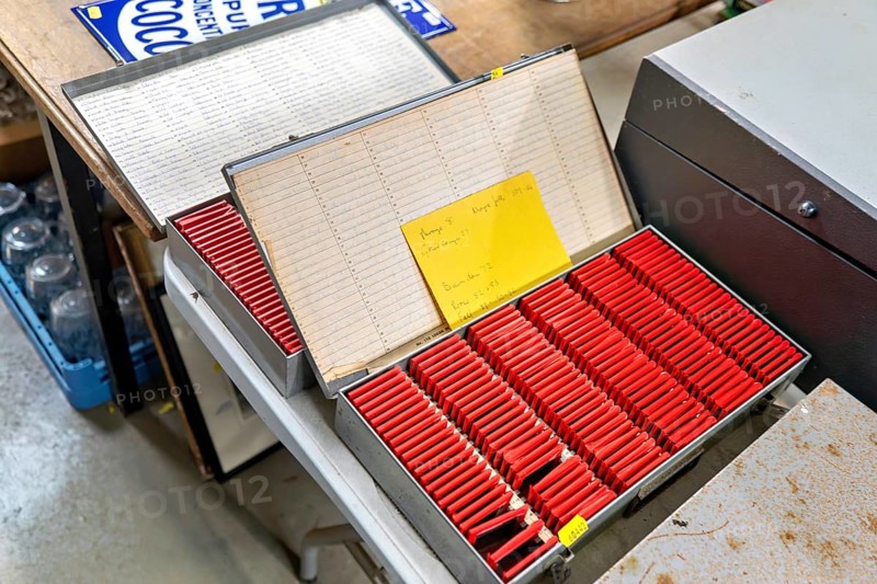 Metal slide storage boxes with vintage 35mm film transparency slides at auction, UK