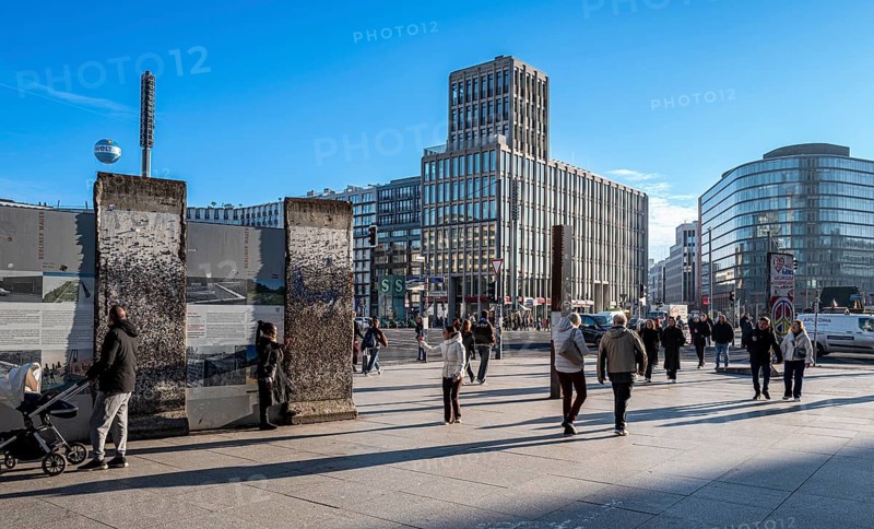 Wall segment, tourists and passers-by at Potsdamer Platz, Berlin, Germany