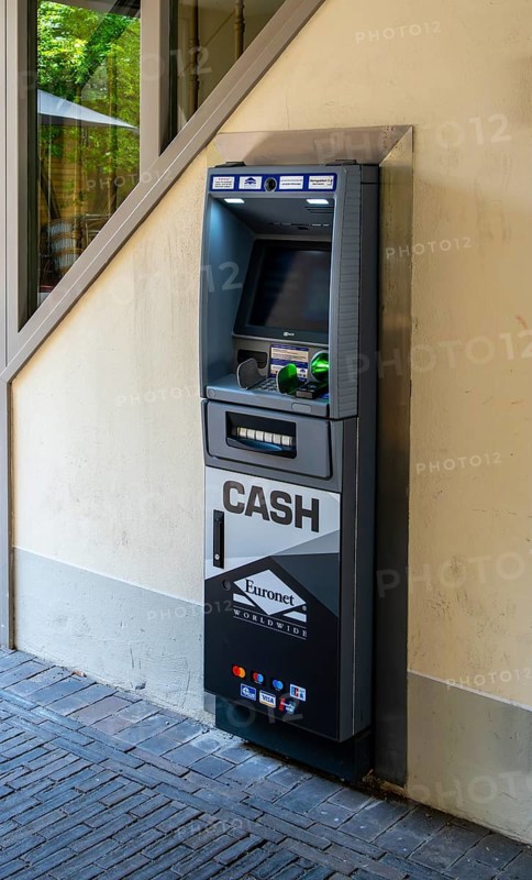 Euronet cash machine at the gateway to a backyard, Potsdam, Brandenburg, Germany
