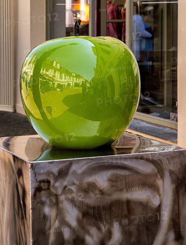 Design of a green apple in front of a shop in downtown Potsdam, Brandenburg, Germany