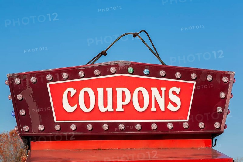 Close-up of the word coupons spelled out in bold white letters on red and maroon colored banner, Quebec, Canada
