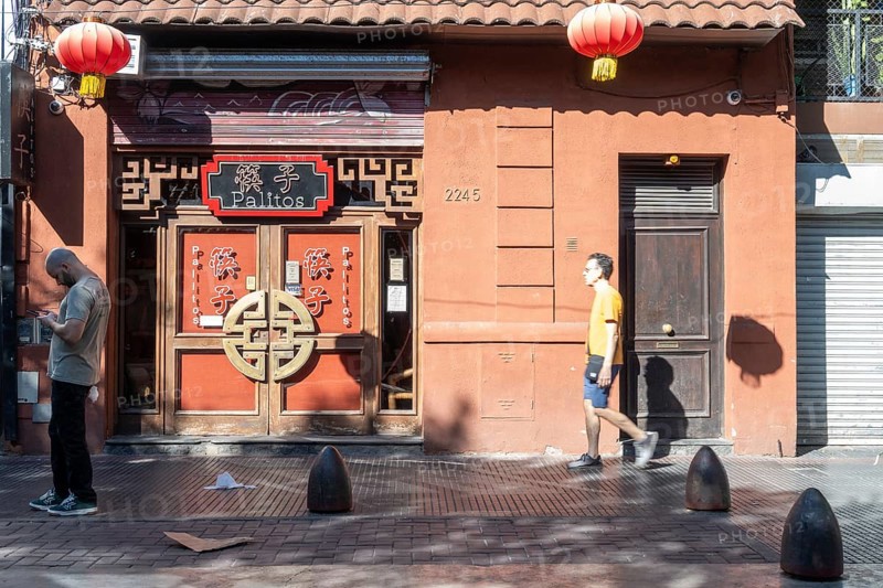 Tourists stroll in Chinatown in front of a Chinese restaurant, Buenos Aires, Argentina