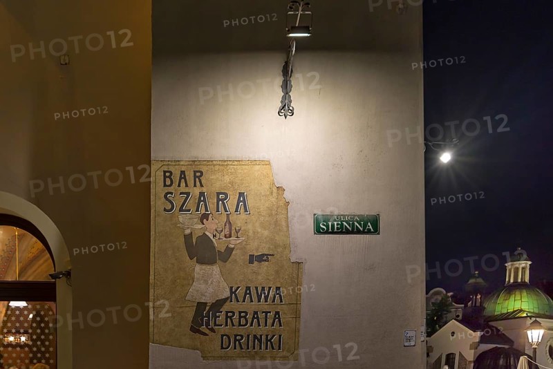 Advertisement for a bar on a house wall, Krakow, Poland