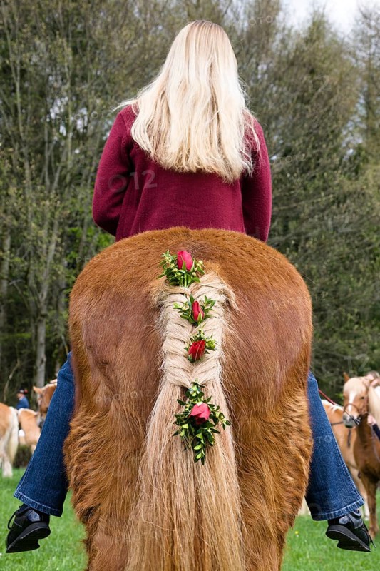 Blonde girl riding decorated horse, traditional Georgian ride at the Penzberg Hubkapelle, Upper Bavaria, Germany
