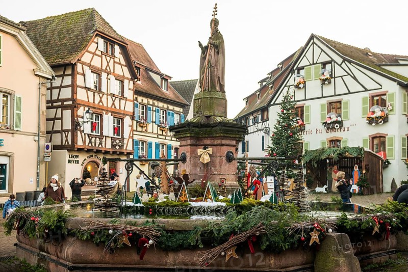 Christmassy decorated houses and fountains with half-timbered houses, Christmas market, Eguisheim, Haut-Rhin department, Grand Est region, Alsace, France