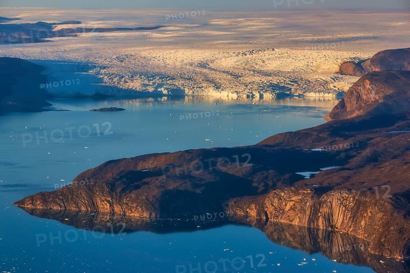 Aerial view of coast and Greenland ice sheet, Arctic landscape, frozen wilderness, glaciers and snow-covered terrain, Climate change, Global warming, Greenland, North America