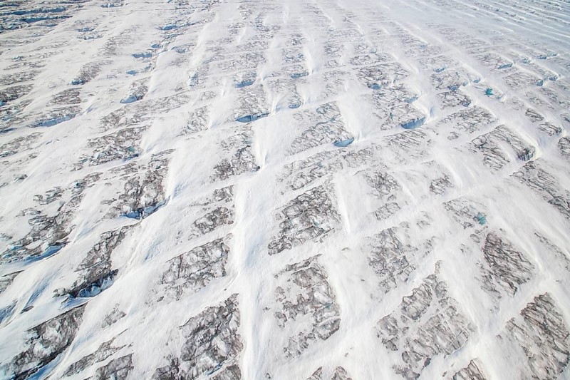 Aerial view of Ice sheet in Greenland, Arctic landscape, frozen wilderness, glaciers and snow-covered terrain, Climate change, Global warming, Greenland, North America