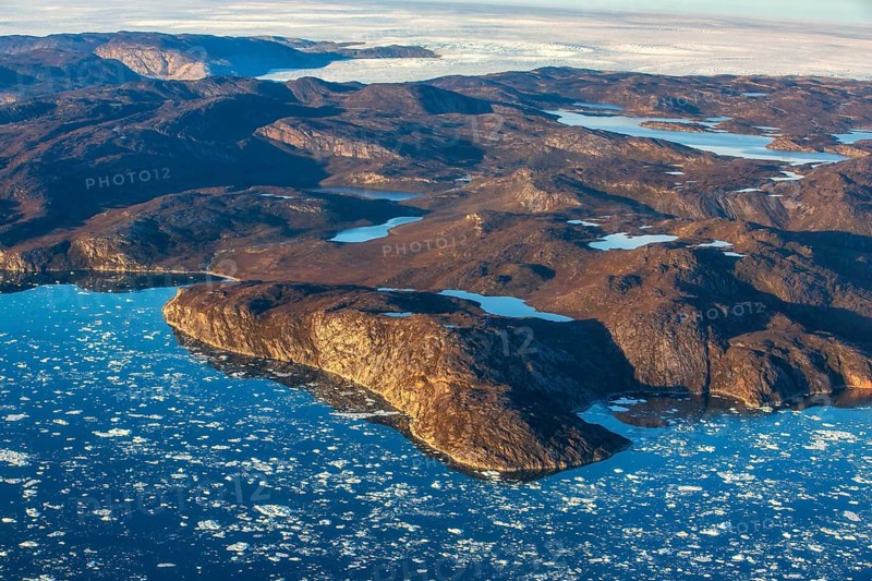 Aerial view of the coast and Greenland ice sheet, Arctic landscape, frozen wilderness, glaciers and snow-covered terrain, Climate change, Global warming, Greenland, North America