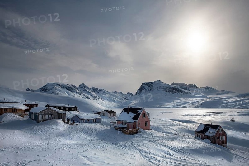 Tiniteqilaaq covered in snow during winter. The village is one of five settlements around Ammassalik Island, located in the Sermersooq municipality on Ikasativaq Fjord, north of Ammassalik Island and facing Sermilik, Greenland, North America