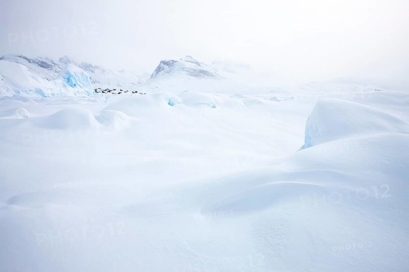 Tiniteqilaaq covered in snow during winter. The village is one of five settlements around Ammassalik Island, located in the Sermersooq municipality on Ikasativaq Fjord, north of Ammassalik Island and facing Sermilik, Greenland, North America