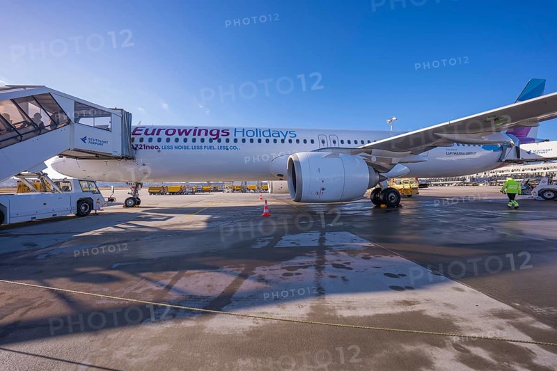 Eurowings aircraft on the ground with mobile stairs and clear blue sky in the background, Stuttgart Airport, Germany