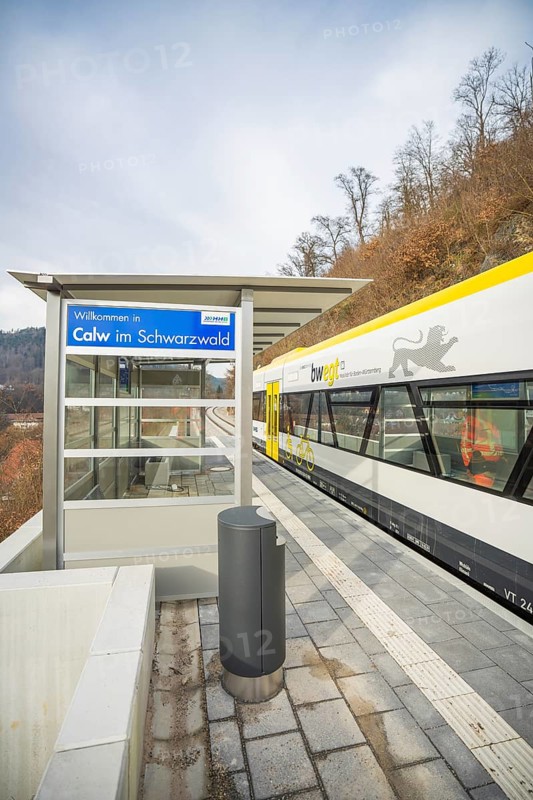 A train station in Calw in the Black Forest with a train and wooded landscape in the background, taking off the Hermann Hessebahn, Calw, Germany