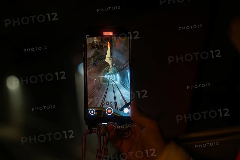 Smartphone shows video recording of an illuminated tunnel in a dark environment, the Hermann Hessebahn's journey, Calw, Germany