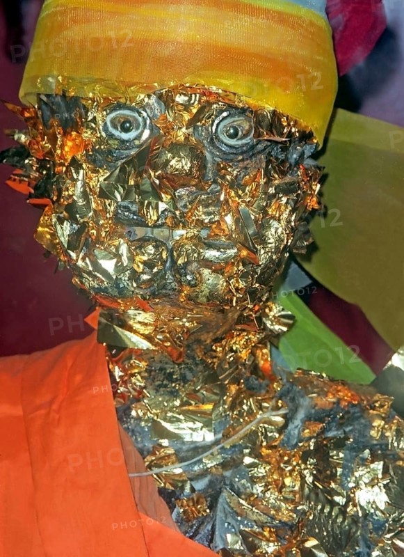Statue of a monk in a Buddhist temple decorated with gold plates. Buddha, Buddhism, religion, Phuket, Thailand, Southeast Asia
