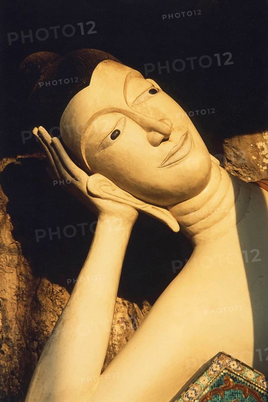 Reclining alabaster Buddha at Wat Sai Thai. The reclining Buddha symbolizes the last earthly hours in front of entering Nirvana. This state is called Paranirvana, a state reserved only for enlightened beings at the end of their lives. Buddhism, religion, Krabi, southern Thailand, Thailand, Southeast Asia
