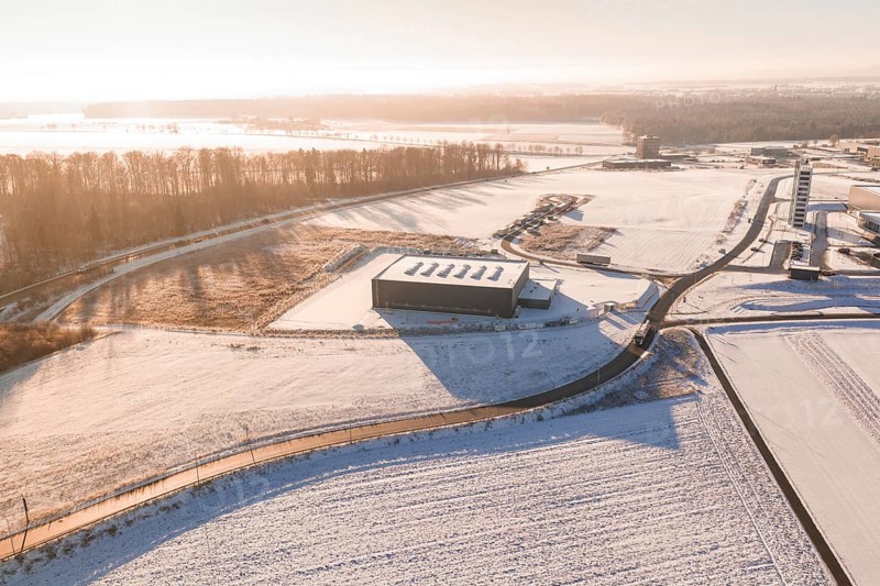 Snow-covered industrial plants and fields under clear sky at sunrise, Nagold, Calw district, Black Forest, Germany