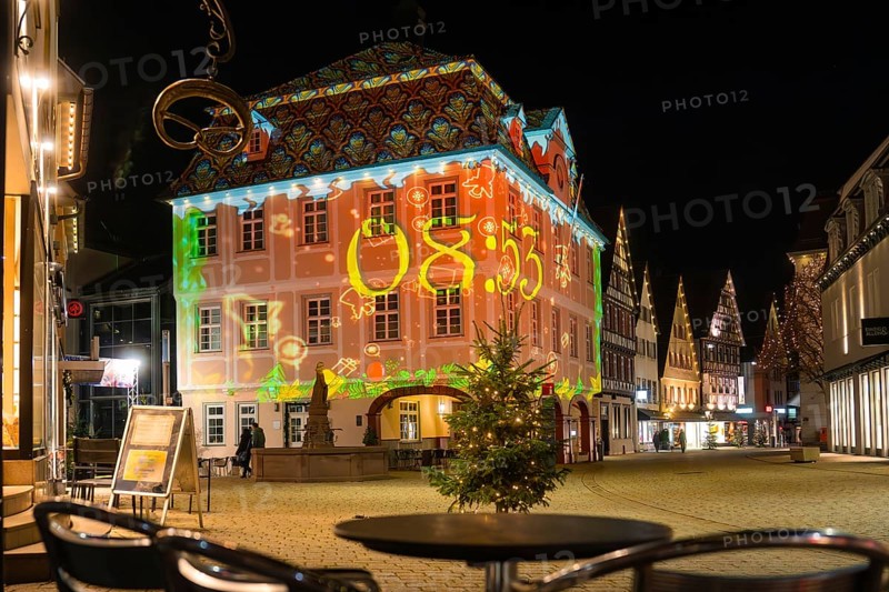 Historic building at night with colorful light projection in the festively decorated city center, Nagold, Calw district, Black Forest, Germany