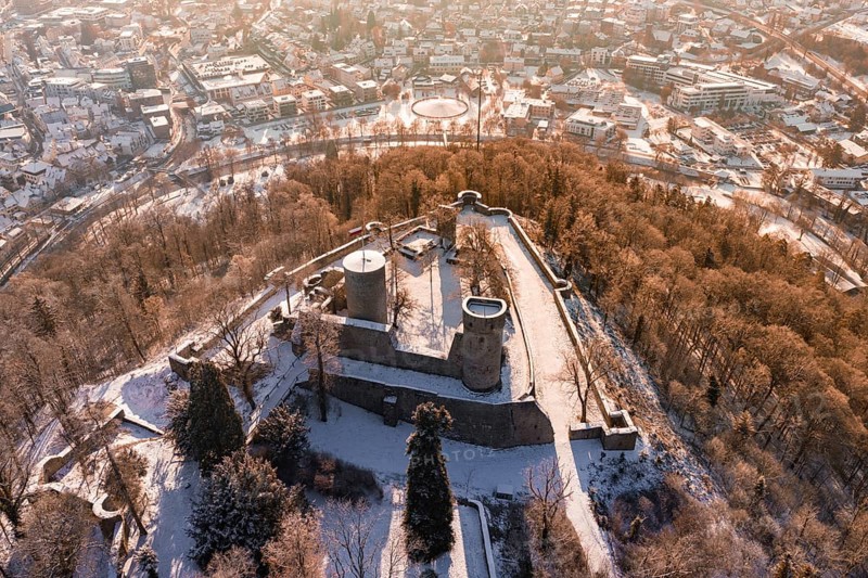 Panoramic view of a snowy castle with city in the background, surrounded by trees, Nagold, Calw district, Black Forest, Germany