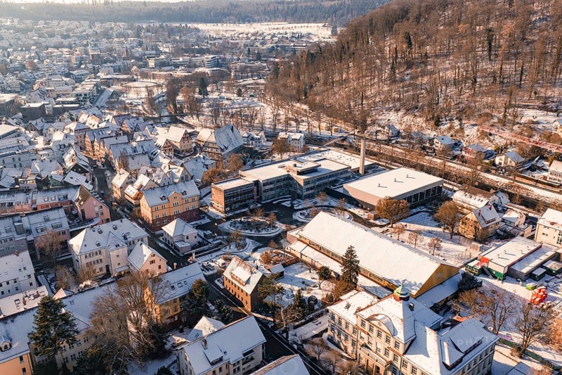 Aerial view of a snowy town surrounded by forest landscape and hills, Nagold, Calw district, Black Forest, Germany