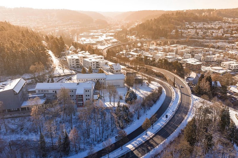 Snowy city landscape with a bridge and roads surrounded by hills and trees, Nagold, Calw district, Black Forest, Germany