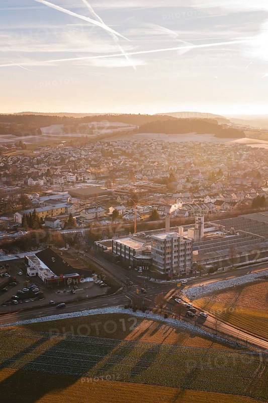 Urban panorama at sunset, pastel colors in the sky, surrounded by fields and snow-covered areas, Althengstett, Calw district, Germany