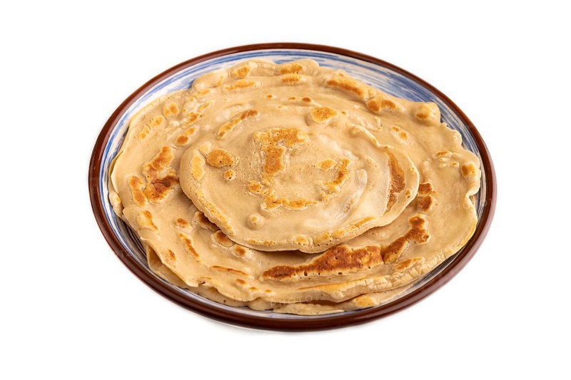 Stack of Plain Fried pancakes Isolated on white background. side view, close up