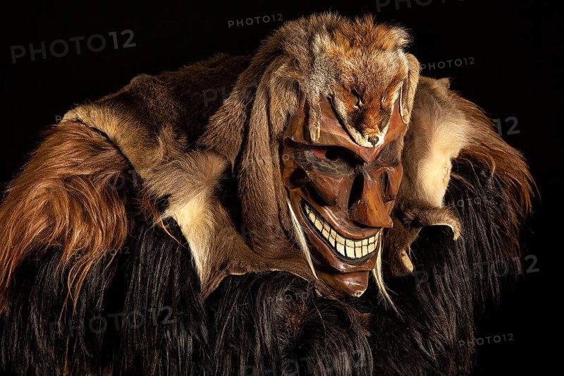 Portrait of traditional hand-carved wooden mask from the Loetschental Carnival, representing folkloric characters, spirits, and demons, Loetschental village, Valais Canton, Switzerland