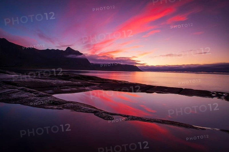 Coastal view in Senja, Norwegian Sea, rugged cliffs and mountains composed mainly of Precambrian gneiss and granite, Norway