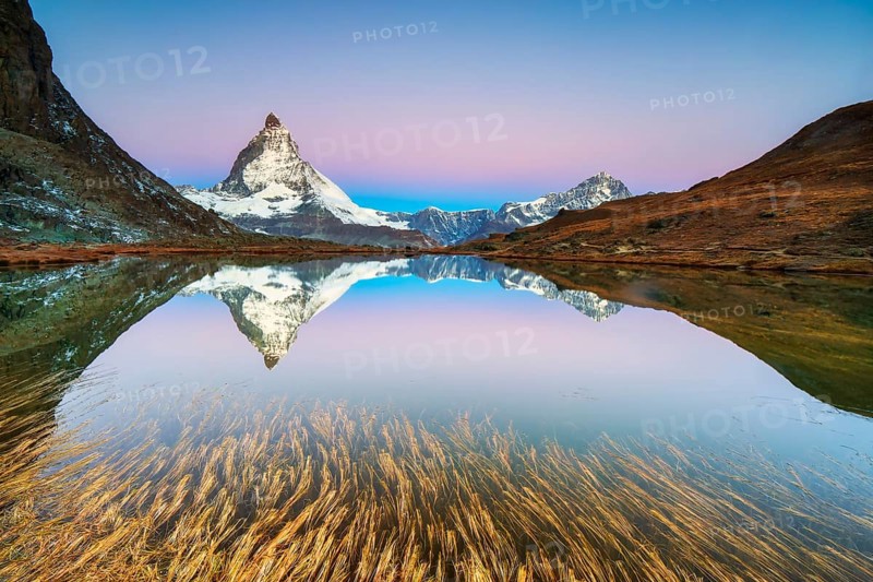 Matterhorn at 4, 478?m, iconic symbol of Switzerland, reflected in Riffelsee Lake at sunrise in autumn, Zermatt, Valais, Switzerland