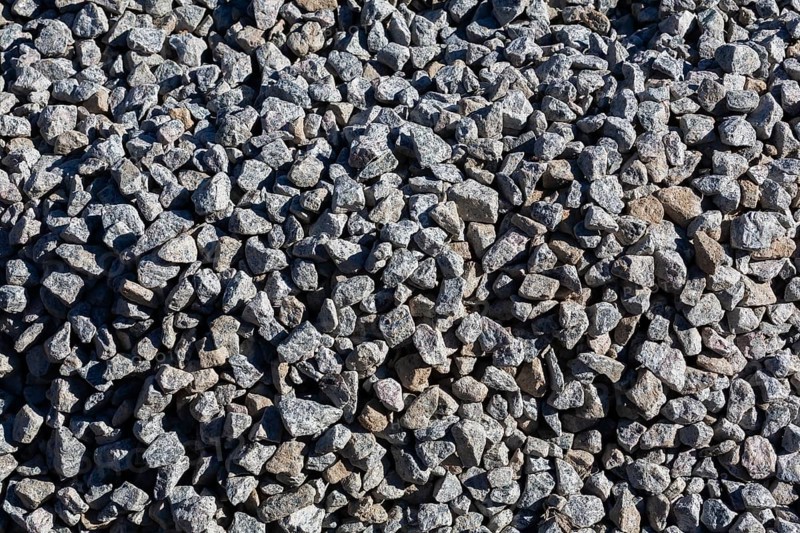 Close-up of grey crushed stone aggregate used to form a bed for constructing roads and driveways on, Quebec, Canada