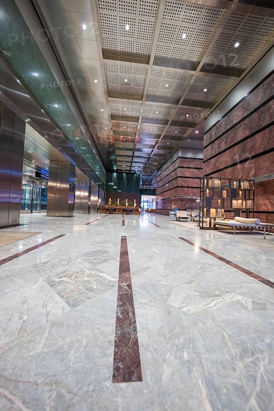 A spacious, minimalistic lobby with marble floors and modern furniture, London, England, United Kingdom