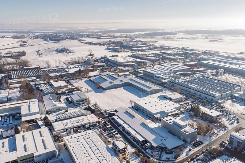 Extensive industrial area under a blanket of snow and clear skies, Wolfsberg industrial area, Nagold, Germany
