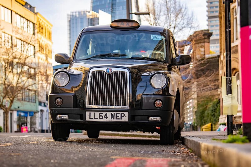 A black London taxi parked on a city street, London, England, Great Britain