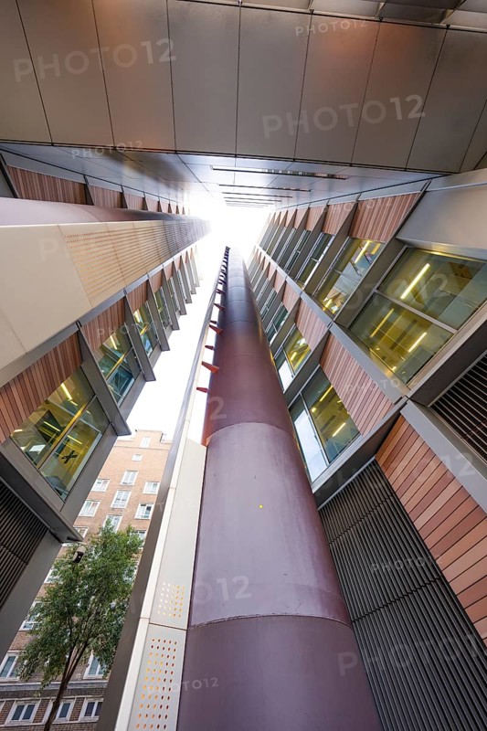 A symmetrical upward look between two modern buildings, London, England, Great Britain